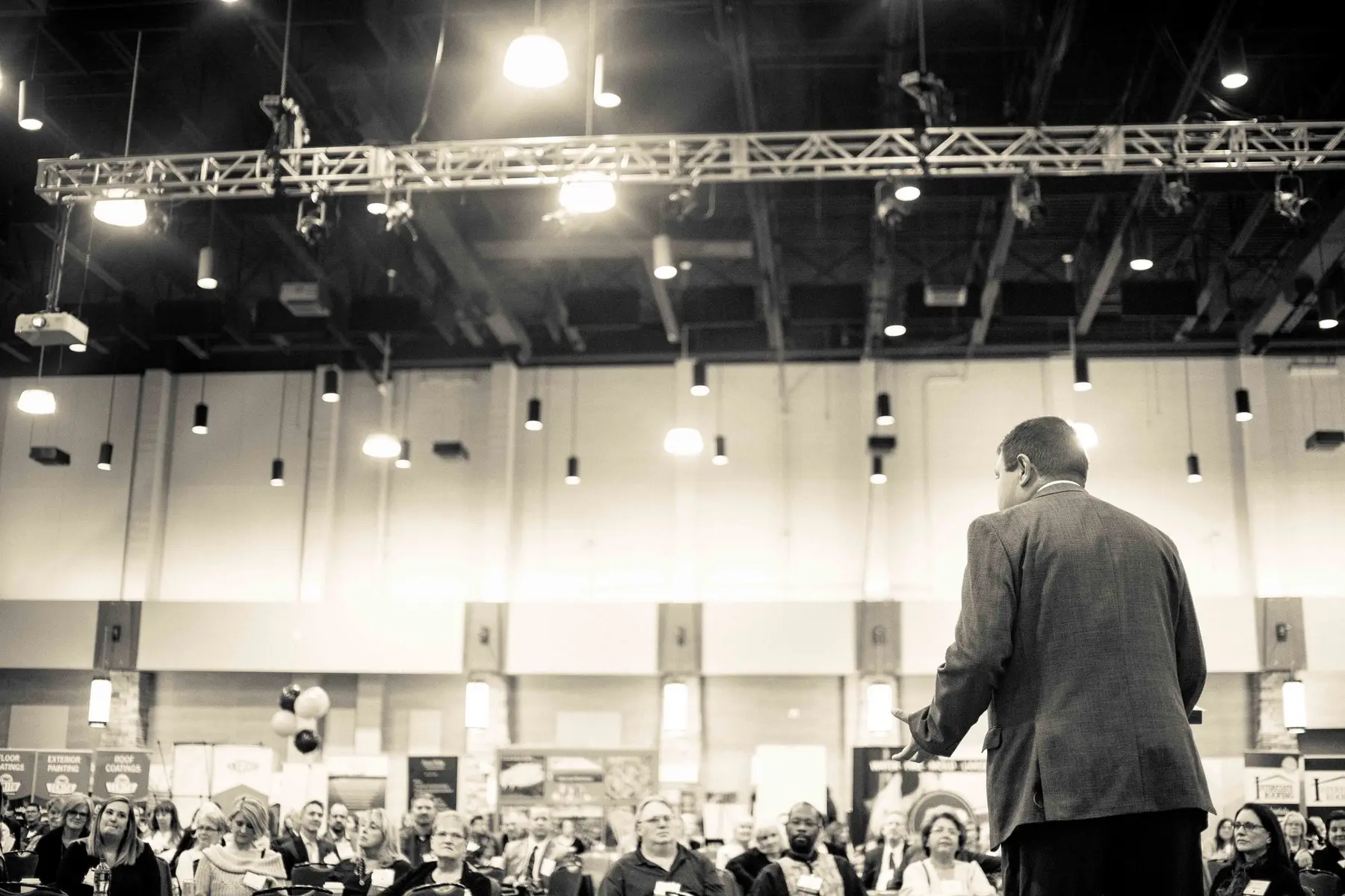 Arjun Sen on a keynote stage, seen from behind